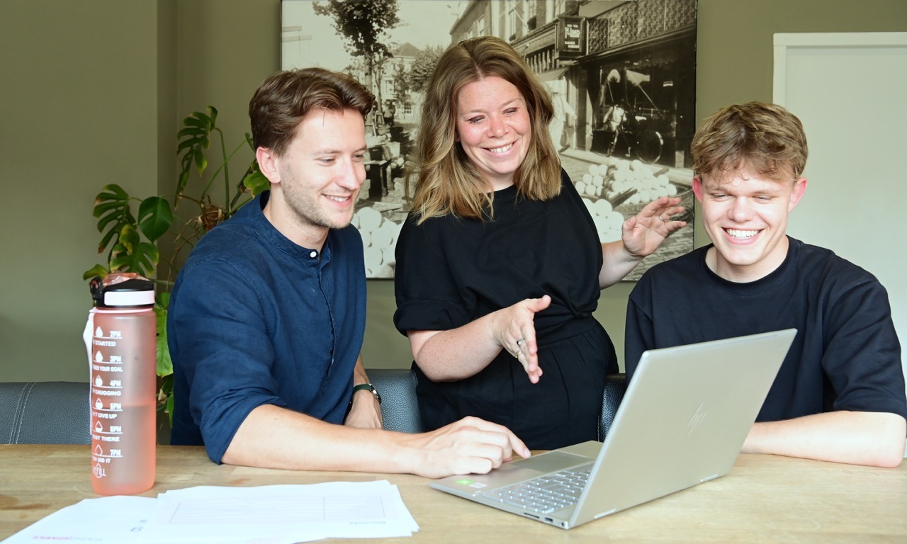 3 marketeers bespreken de emailmarketing met een laptop